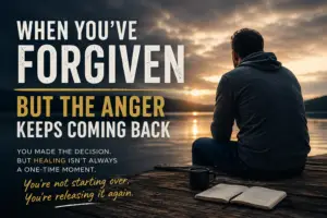 A man sitting alone on a dock at sunset with an open Bible and coffee nearby, reflecting on forgiveness, anger, healing, and releasing pain again.