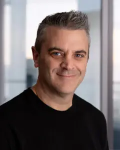 Portrait photo of a man with short gray hair wearing a black shirt, used as an author or profile image for Faith For Real Life.